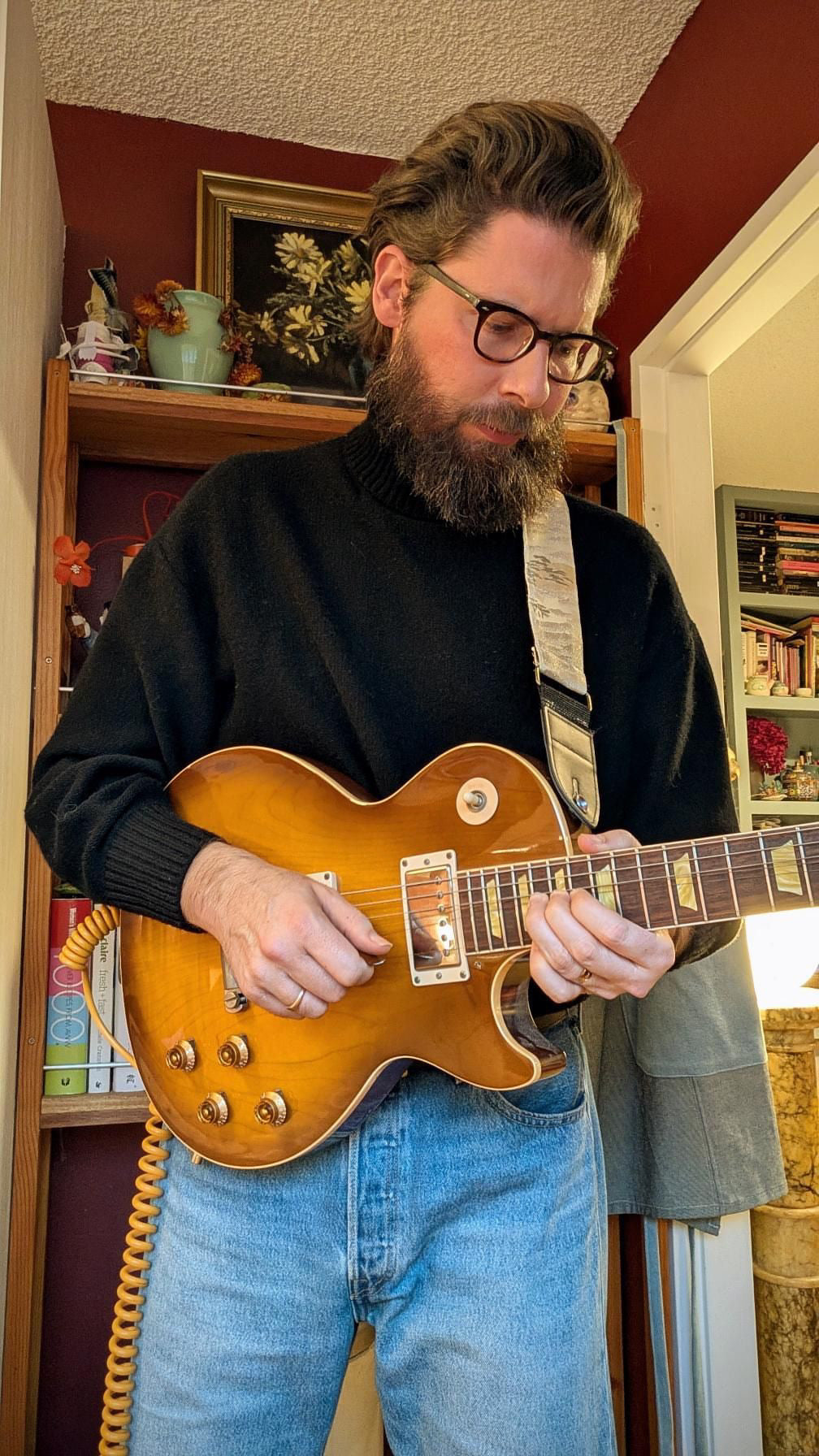 Zane pairing a white-and-silver Obi strap with a single-cut electric guitar